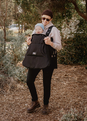 Parent holding a baby in a baby carrier with the baby luno Carrier Cocoon Winter Cover