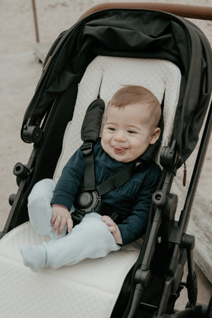 baby sitting on the baby luno Lite Summer Pram Liner Footmuff waffle side