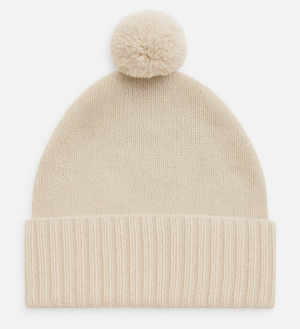 Beige knit beanie with a pom-pom on a white background